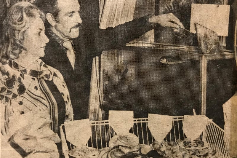The Golden Guinea, which became Bacchus in 1981, was once noted for its food. This photo from 1975 shows owners Stan and Mandy Roberts with a newly installed trout tank, from which customers could choose their fish.