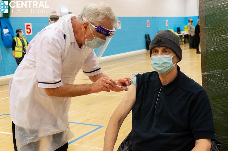 Nurse David Wilson, 69, who has come out of retirement to help with the vaccination programme, gives John Nicholson his immunisation.