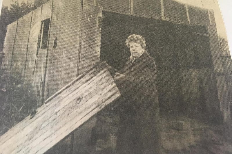 Resident Mrs Dorothy Pearce pictured with her partly demolished garage after her garden had been wrecked by vandals and workmen following a development following a modernisation of homes