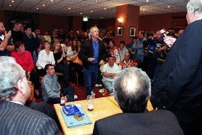 Fans have their say at a public meeting after plans to merge Hunslet Hawks and Bramley were unveiled in October 1999. Chairman Graham Lyles is confronted by an angry supporter.