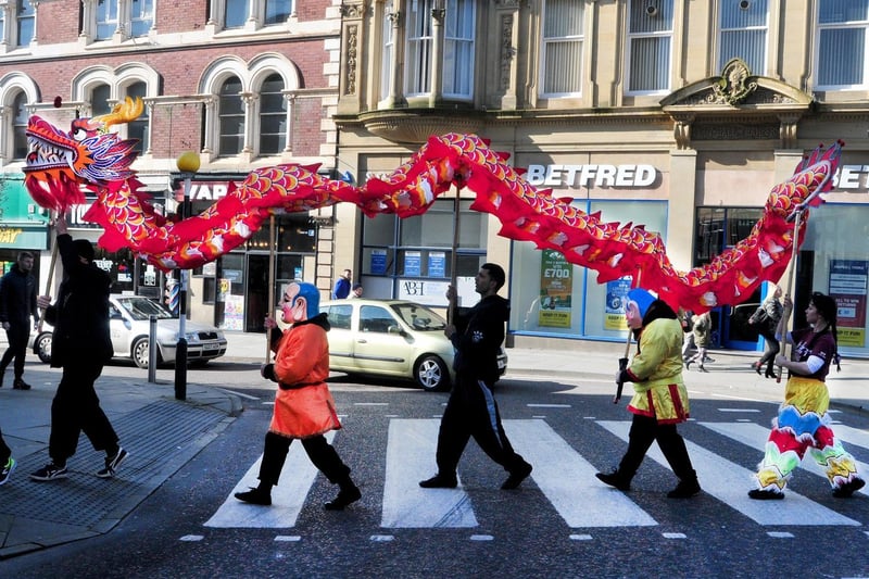 Chinese dragon performance through Wigan Town Centre in 2018.