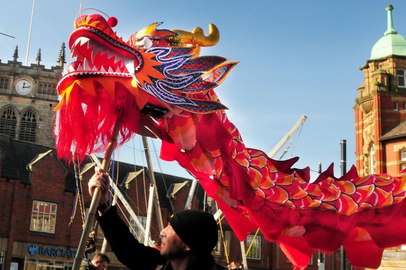 The dragon performance through Wigan town centre, 2018.