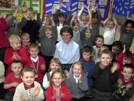 February 2003 and Pauline Bannister celebrates her long service award from Education Leeds with pupils at Raynville Primary after working as a teacher for 34 years.
