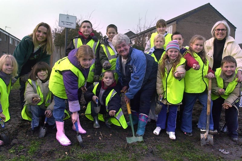 December 2003 and the community came together for bulb planting on the Rossefield estate. Pictiured are pupils from St Peters C of E with Audrey Maskill, chair of Rossefield Residents Association, Coun Denise Atkinson, and warden Michelle Fisher.