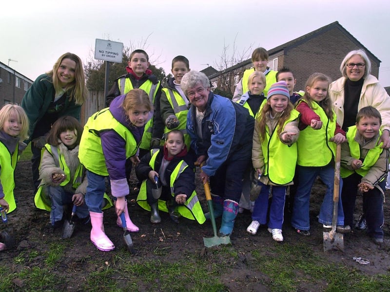 December 2003 and the community came together for bulb planting on the Rossefield estate. Pictiured are pupils from St Peters C of E with Audrey Maskill, chair of Rossefield Residents Association, Coun Denise Atkinson, and warden Michelle Fisher.