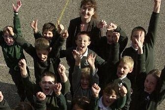 Children and deputy headmistress Anne-Marie Reeve celebrate Greenhill Primary School's excellent Oftsed report in October 2003.