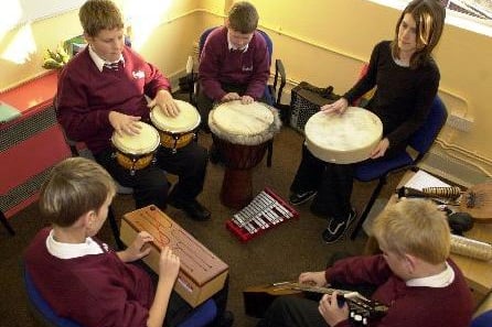 September 2003 and music therapist Rebekah Betts works with children at Intake High School.