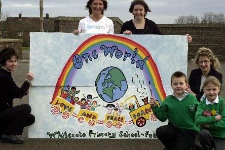 March 2003 and Whitecote Primary pupils Steven Doogan and Hannah Hilton with deputy head teacher Corinne Penhale (right) and parents Jackie Mollett, Joanne Hall and Tracey Tweed who made this mural as part of the school's multicultural week..