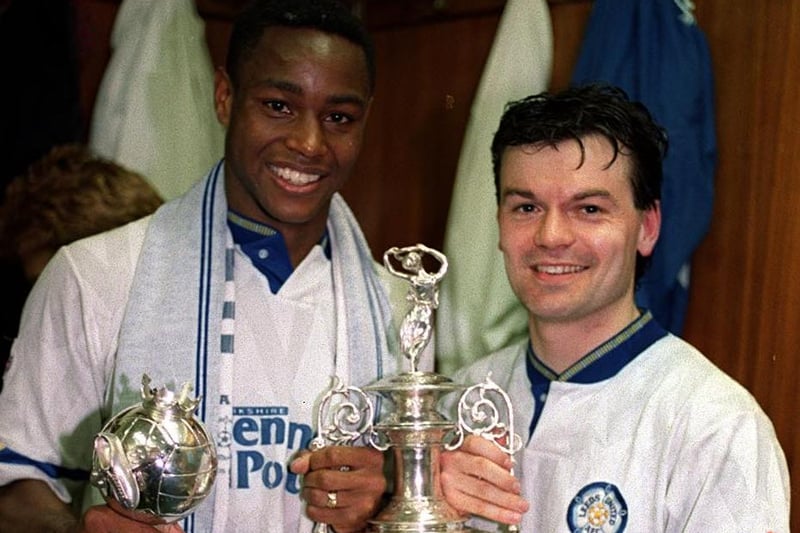 Steve Hodge gets his hands on the First Division champions trophy with teammate Chris Fairclough.
