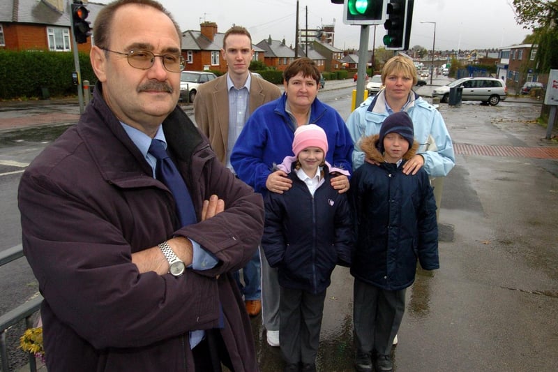 November 2005 and campaigners were calling for a lollipop person to patrol Lupton Avenue. Pictured is Brownhill Primary headteacher Alan Scott with vice chair of governors Andy Charlwood, chair of governors Diane Wardman, daughter Emily, and parent Carol Mellor with son Nicholas.
