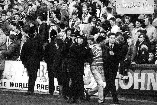 A press photograph of police removing a Featherstone supporter at the Yorkshire Cup Final match, Featherstone v. Bradford