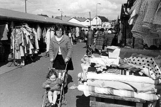 A press photograph of shoppers in the clothing and textile area of Castleford market