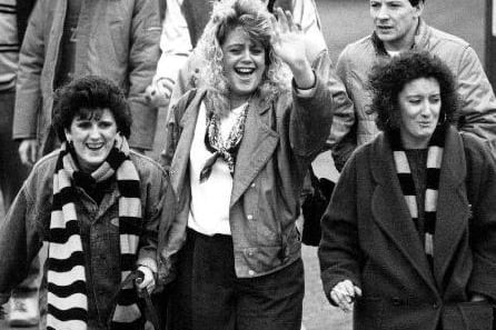 A press photograph of happy supporters for a Castleford v. Widnes game in the 1980s