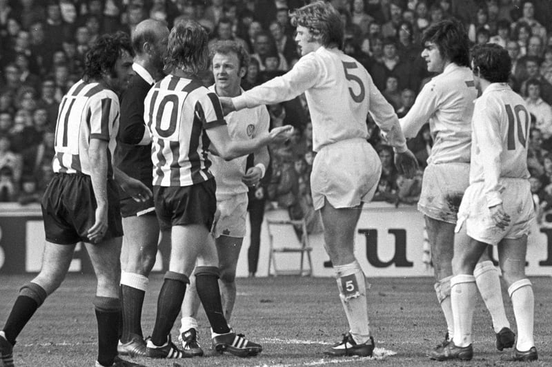 Gordon McQueen plays peacemaker during Leeds United's goalless draw with Sheffield United at Elland Road in April 1974.
