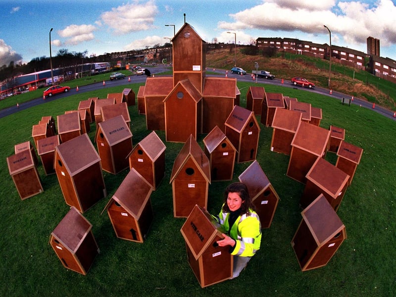 Artist Gill Russell with her Cardboard City on the Leeds Ring Road roundabout.