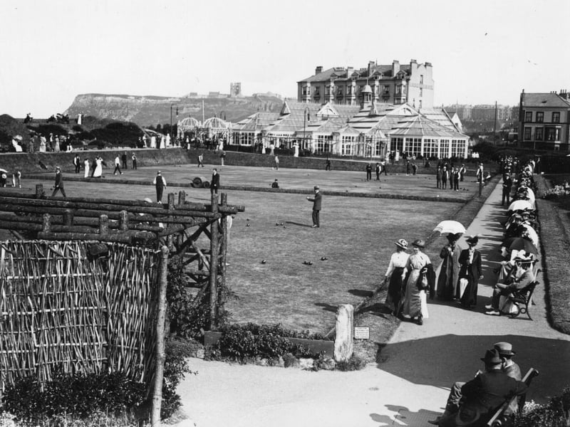 circa 1890: The bowling green at Alexandra Gardens, Scarborough, with the Floral Hall in the background.