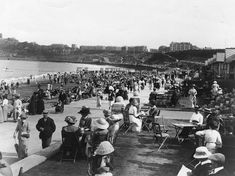 1913: Crowds of promenaders and onlookers out on the Scarborough sea front.