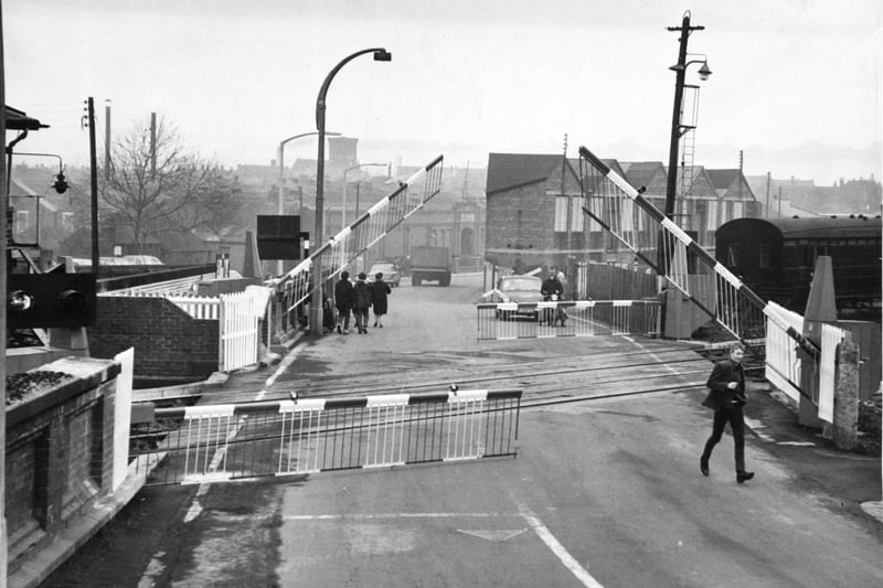 Pedestrians cross the level crossing on Albion Street, Castleford, in December 1967.
