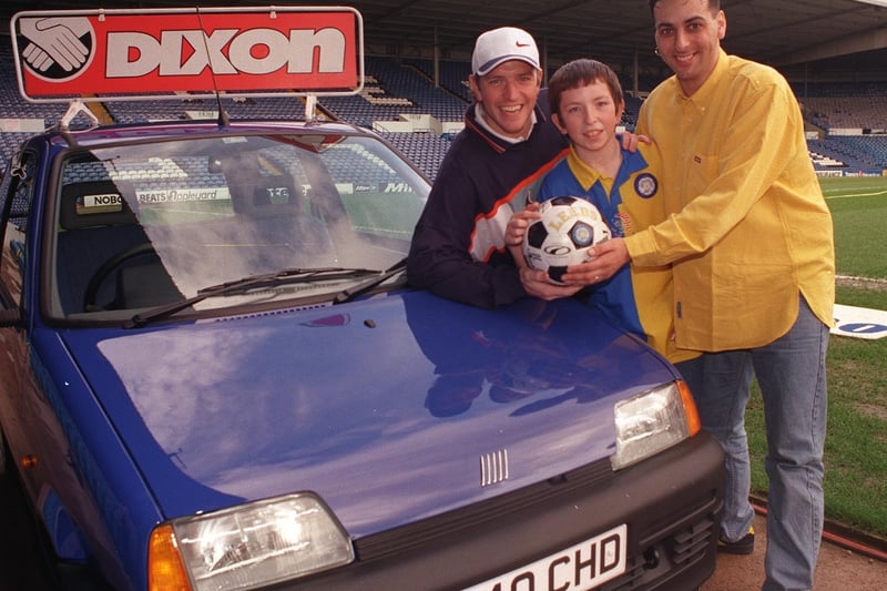 March 1998 and this is Paul Dixon and son Andrew from Cross Gates who was celebrating after winning a Fiat Cinquecento during an Elland Road half-time penalty shoot-out. Also pictured is Lee Sharpe.