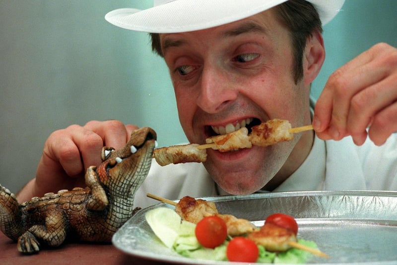 John Green, of Wilsons Butchers, bites into the shop's new barbeque special, a crocodile kebab.