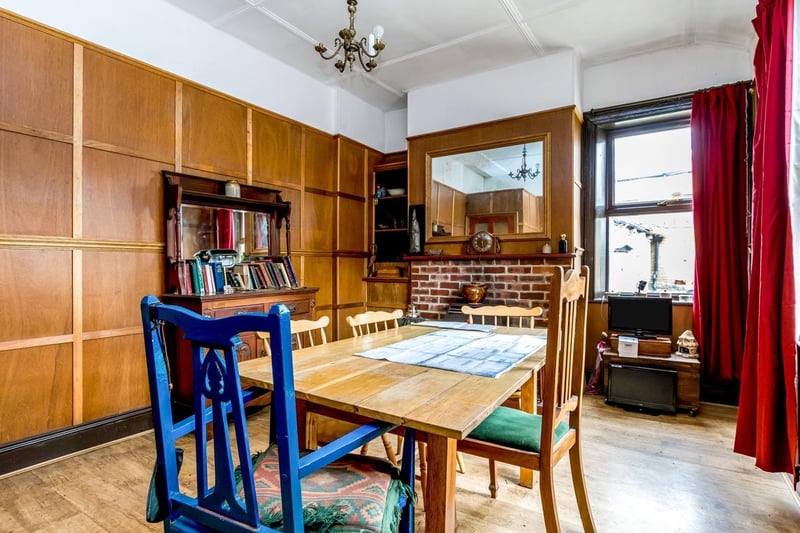 The dining room has feature panelled walls around the room and is filled with natural light. There is a gas fire with exposed brick surround, a central heating radiator and television point.