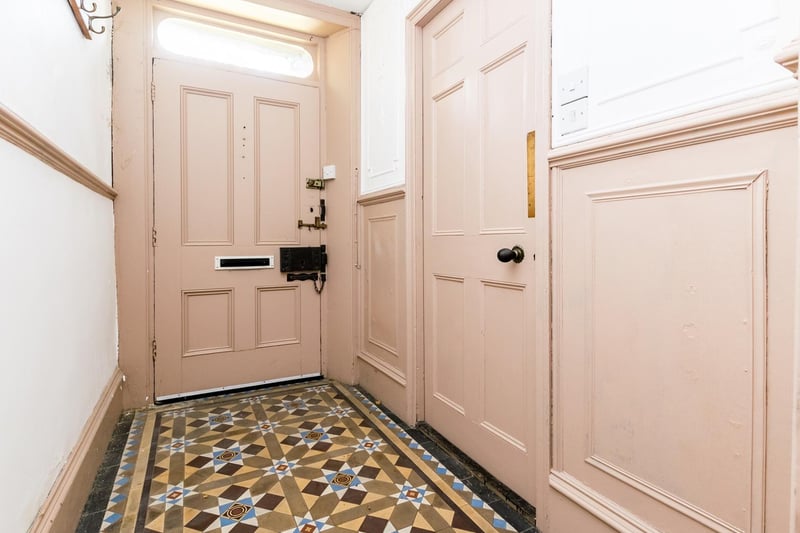 Enter through the original door, into a bright space with blush painted panelling and a unique tiled floor. The house can also be entered through the rear entrance, accessed through the gated, cobbled driveway.