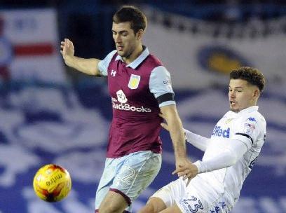 Kalvin Phillips is challenged by Aston Villa's Gary Gardner.