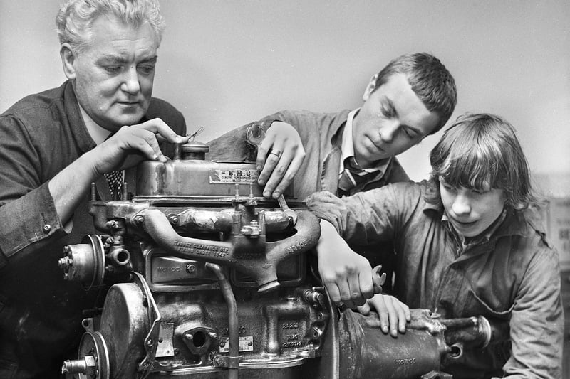 Teacher Norman Little with pupils Tom Mercer and Clifford Cunliffe at work on a car engine in March 1972 at Hindley County Secondary School.