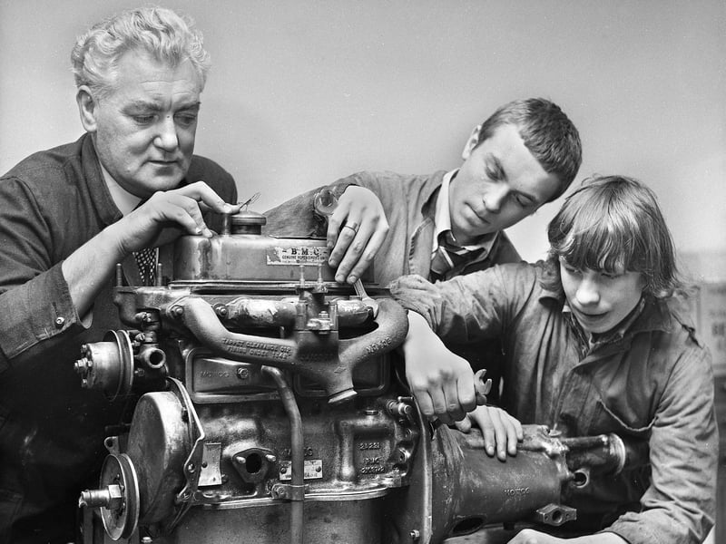 Teacher Norman Little with pupils Tom Mercer and Clifford Cunliffe at work on a car engine in March 1972 at Hindley County Secondary School.