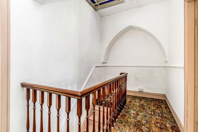 The light and airy second floor landing is full of character. The beautiful arches in the wall point upwards to the stunning stained glass skylight.