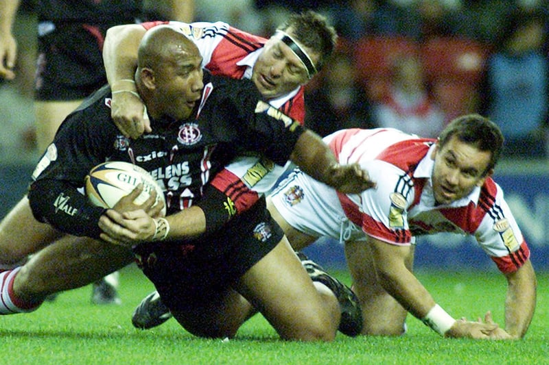 Rugby action as St Helens' Vila Matautia is brought down by Wigan's David Furner and Matthew Johns (right) during the Tetley's Bitter Super League Final Eliminator game at the JJB Stadium, Wigan, Saturday 6th October 2001