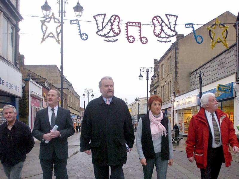 January 2004 and retail development plans the town centre were unveiled. MP Colin Challen (middle) assesses vacant shops with Morley Chamber of Trade members, from left, John Rhodes, Stephen Kearns, Susan Wood and Keith Robinson.