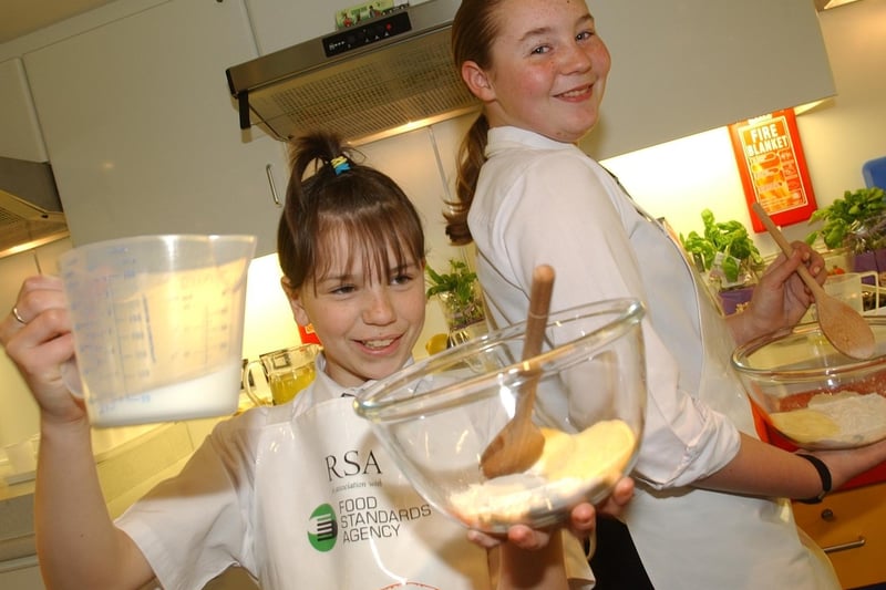 April 2004 and Morley High School pupils - Nicole Beck (left) and Rhian Turner -  how off their  skills on the Food Standards Agency cooking bus.