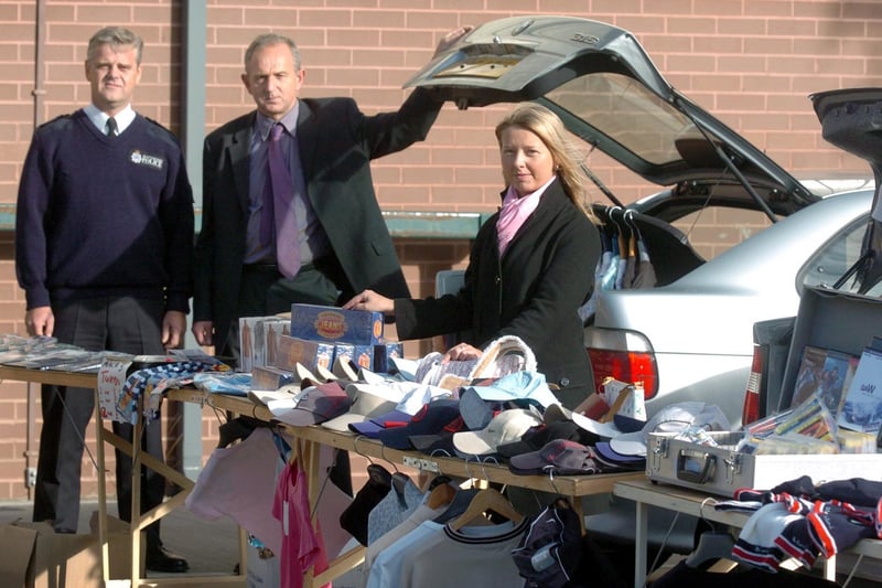 October 2004 and West Yorkshire Trading Standards held a mock car boot sale at their Morley base. Pictured is education and promotions officer Caroline Melton with Chief Insp Mark Busley (left) and Coun Keith Wakefield.
