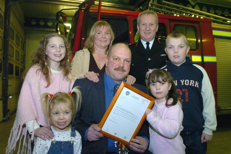 Fire rescue hero Michael Gettings with family after receiving his letter of appreciation from assistant chief fire officer Allan Hughes at Morley Fire Station. Pictured with Michael is wife Helen and children Michaela, Aaron, Kara and Cerys.