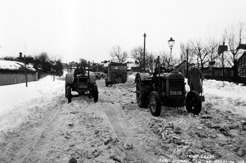 Agricultural tractors on Alwoodley Lane at Alwoodley breaking the ice in an attempt to clear the road. On the left the chimney of Moss Hall can be seen.