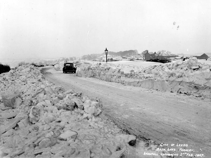The depth and severity of the snowfall can be seen on Back Lane at Farnley. The snow ploughs have revealed the amount of snowfall, on the right.