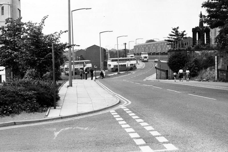Looking along Lower Town Street in July 1980 with the entrance road to Bramley Shopping Centre in the foreground.