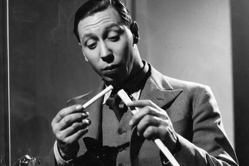 1940 - George Formby stars in the spy comedy 'Let George Do It'.  A still from the film, George has found what appears to be a secret message.