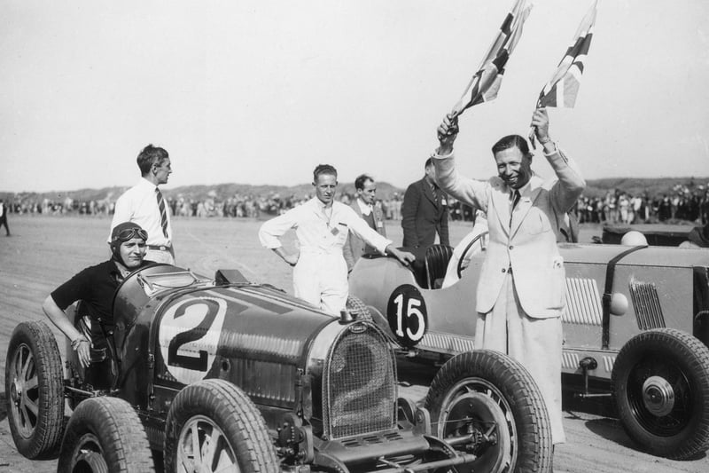 English actor and singer George Formby getting ready to start the Southport Motor Club 10th annual 100-mile Race for Cars in August 1936.