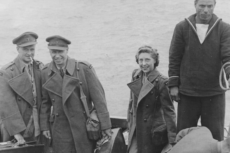 George Formby, second from left, gets ready to step off the flying boat launch in the course of the voyage to England from Burma front, where he had been entertaining the troops in the fighting line.