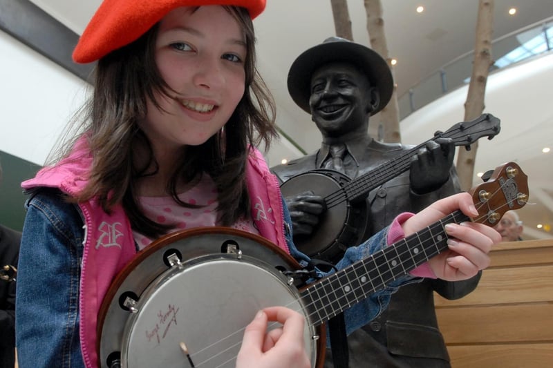 Francesca Davies,12, member of the Wigan George Formby Society with the newly sited statue of George in the Grand Arcade. It was unveiled in September 2007 in The Lane area of the Grand Arcade shopping centre.  In 2009, it was moved nearer to the entrance of the shopping centre.