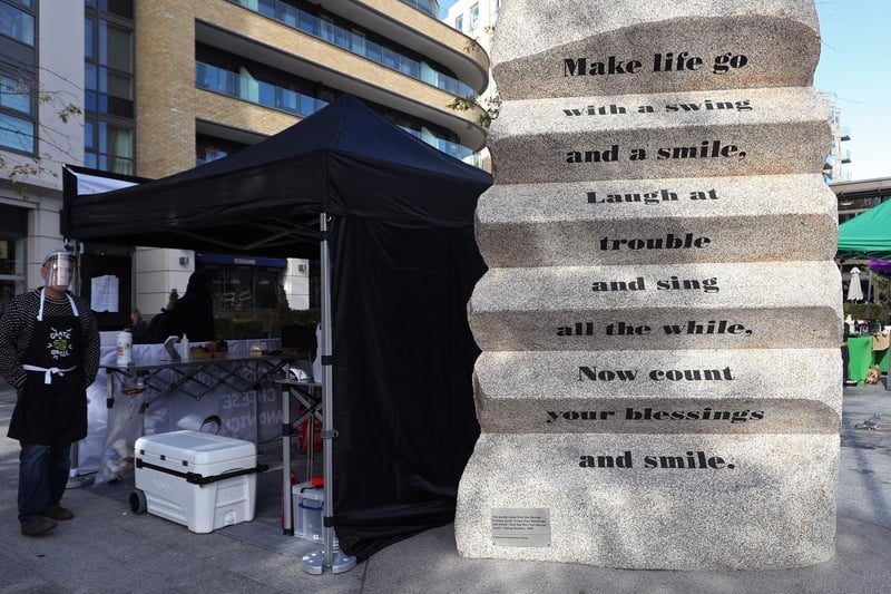 Lyrics from the George Formby song "Count Your Blessings and Smile" written on the side of a public sculpture in Ealing, London.
