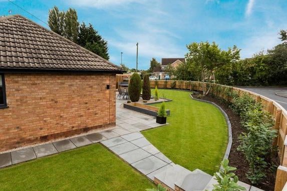 Outside, a fantastic landscaped garden wraps around the property providing a great family space for entertaining, laid mainly to lawn with an Indian slate and decked seating areas. An extensive driveway provides ample off street parking for several vehicles leading to a detached singe garage.