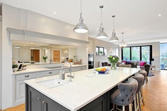 The architect-designed home features a stunning open plan kitchen/dining/family room, with a range of wall and base units, contrasting granite work tops and bi-folding doors to front and rear. The kitchen comes complete with integrated appliances.