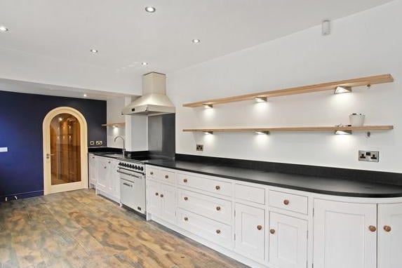 The kitchen is features a range of hand-painted oak wall and base units with contrasting granite worktops, an integrated dishwasher, Falcon Range oven and plumbing for a fridge freezer. Double glazed windows overlook the rear garden with rear entrance door.
