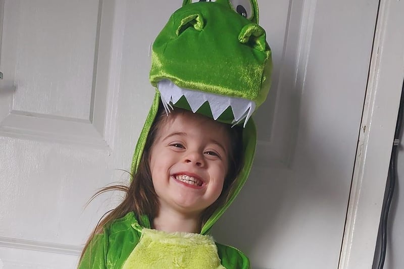 Daisy-May, three, dressed as Rex from Toy Story, but also looks like The Good Dinosaur.