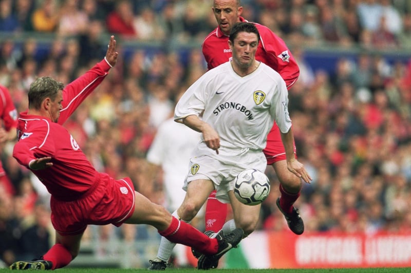 Robbie Keane takes the ball past Liverpool's Stephane Henchoz and Gary McAllister during the Premiership match at Anfield in October 2001. The game finished 1-1.