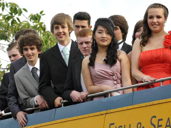 Pupils set off for prom on open top bus.