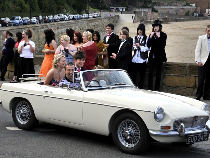 Friends enjoy arriving in a classic car.